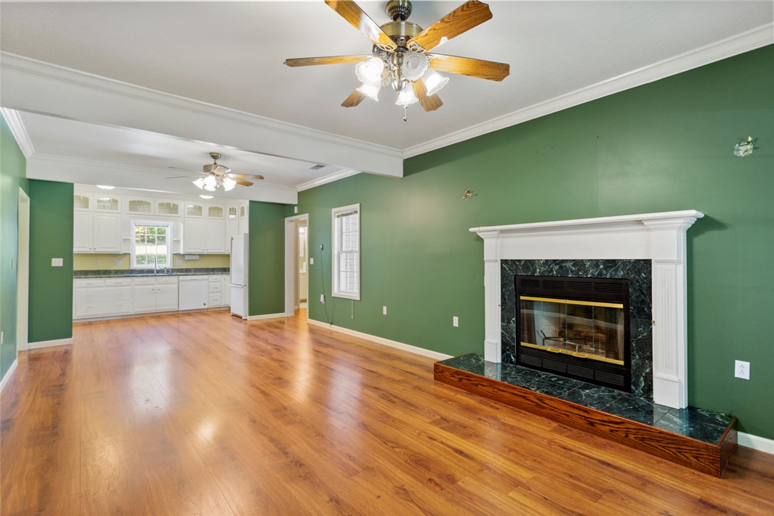 621 Burns Mill Road West Union, SC 29696 - Photo 38 of 45 Hardwood floors complement a cozy fireplace, offering a welcoming atmosphere for daily living and entertaining.
