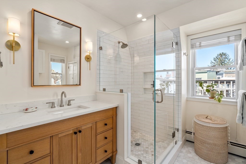 30 Cross Street, Unit 2 Boston, MA 02129 - Photo 11 of 18 a bathroom with a shower sink vanity mirror and toilet