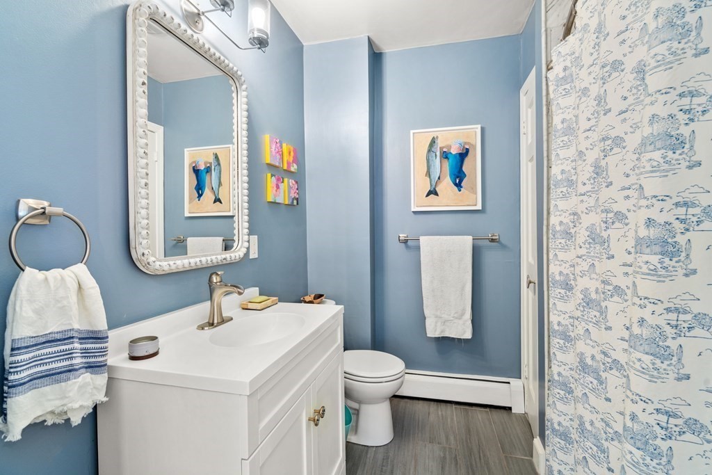 30 Cross Street, Unit 2 Boston, MA 02129 - Photo 8 of 18 a bathroom with a toilet a sink and mirror