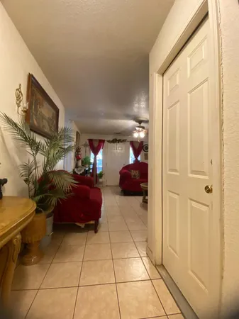 a living room with furniture a flat screen tv and a window