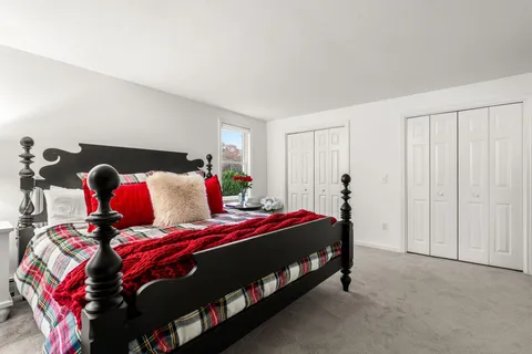 a bedroom with a bed and a tv on the dresser