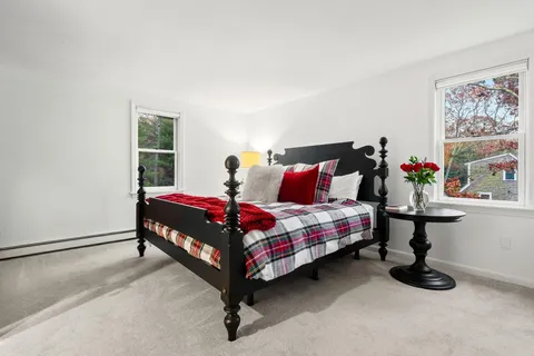 a bathroom with a granite countertop toilet sink and mirror
