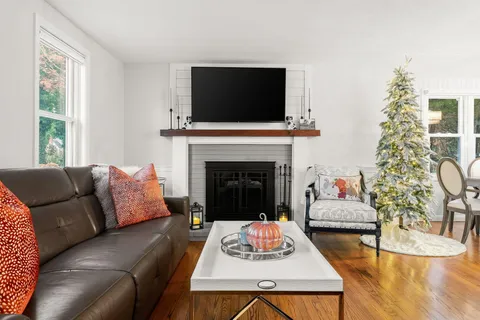 a living room with furniture and wooden floor