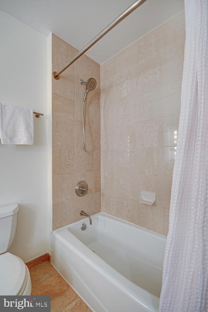 811 4th Street Northwest, Unit 507 Washington, DC 20001 - Photo 14 of 23 a bathroom with a bathtub and a shower