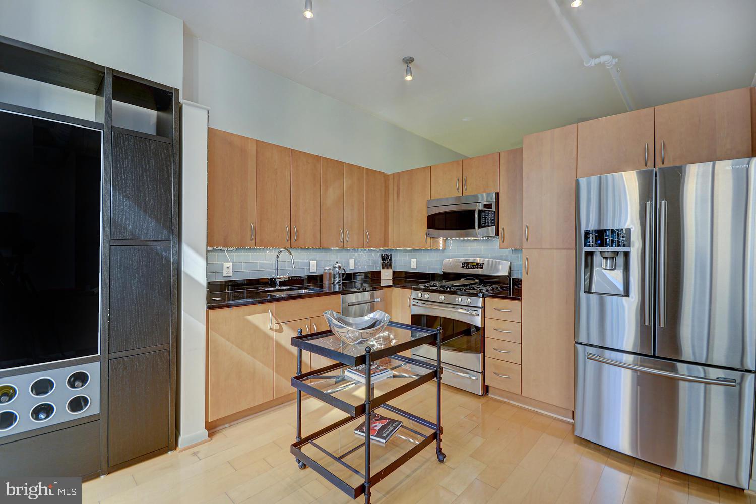 811 4th Street Northwest, Unit 507 Washington, DC 20001 - Photo 6 of 23 a kitchen with stainless steel appliances a stove a refrigerator and a refrigerator