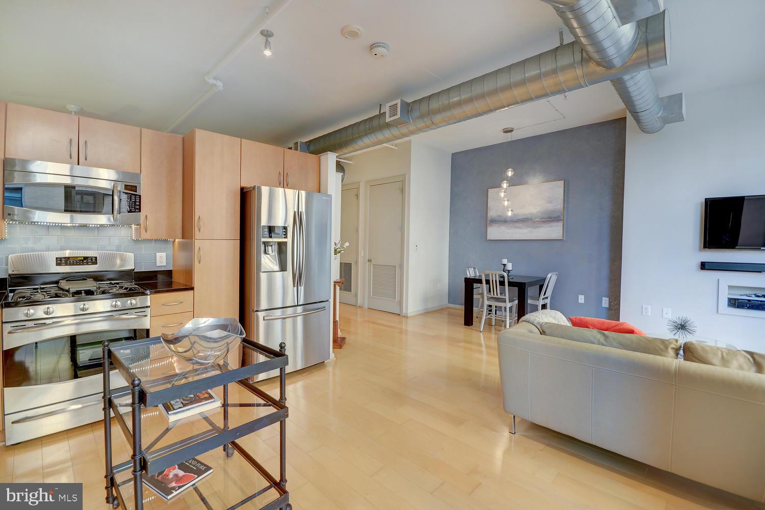 811 4th Street Northwest, Unit 507 Washington, DC 20001 - Photo 7 of 23 a living room with furniture and a flat screen tv