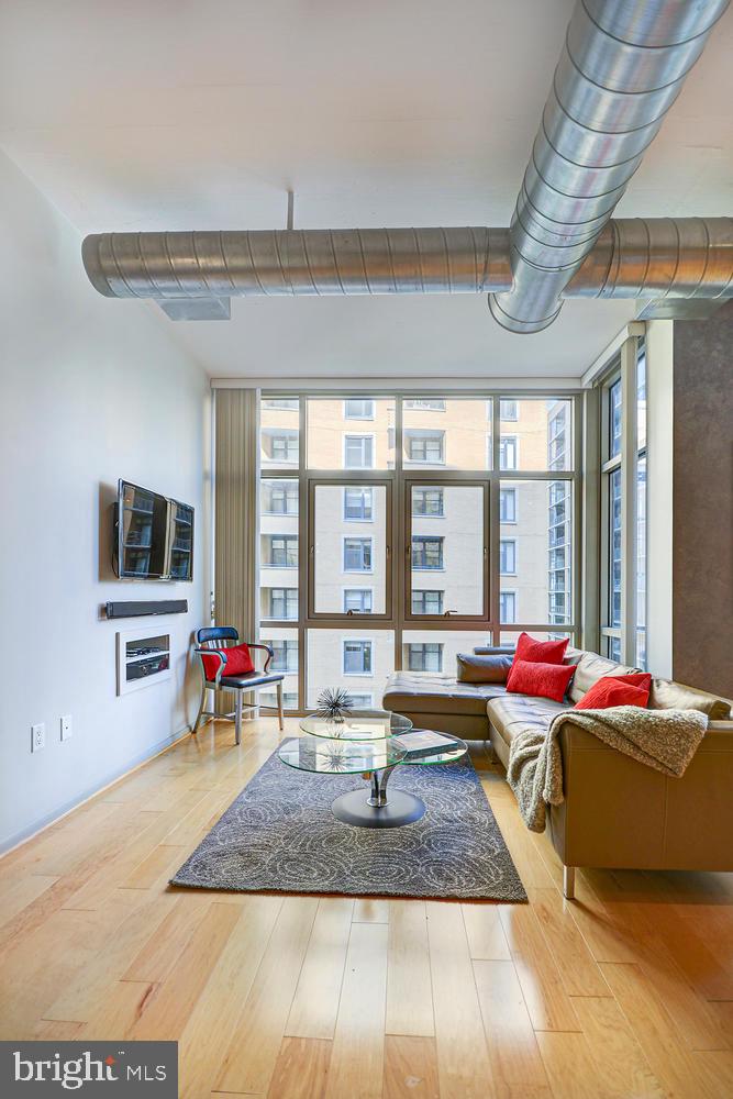 811 4th Street Northwest, Unit 507 Washington, DC 20001 - Photo 10 of 23 a living room filled with furniture and floor to ceiling window