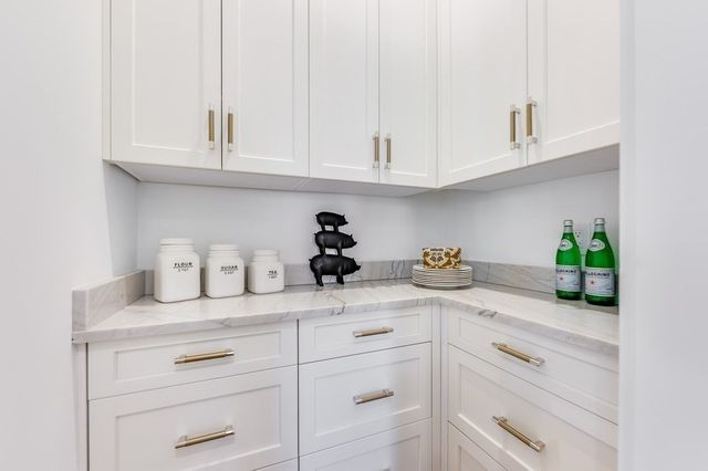 a kitchen with white cabinets and a sink