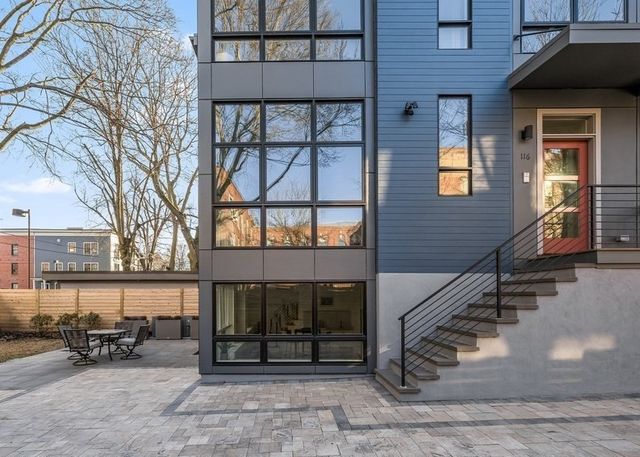 a front view of a house with a yard and parking space
