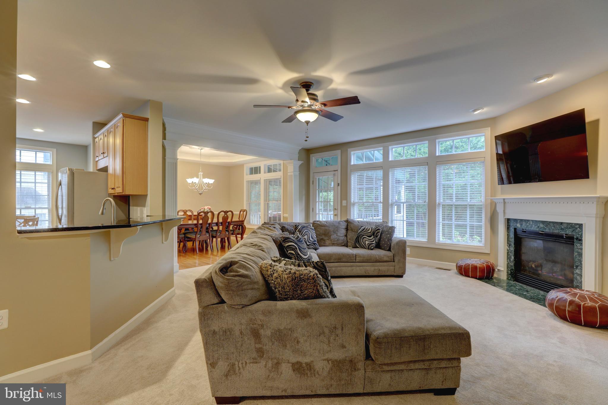 9124 Back Drop Drive Perry Hall, MD 21128 - Photo 13 of 69 a living room with furniture a flat screen tv and a fireplace