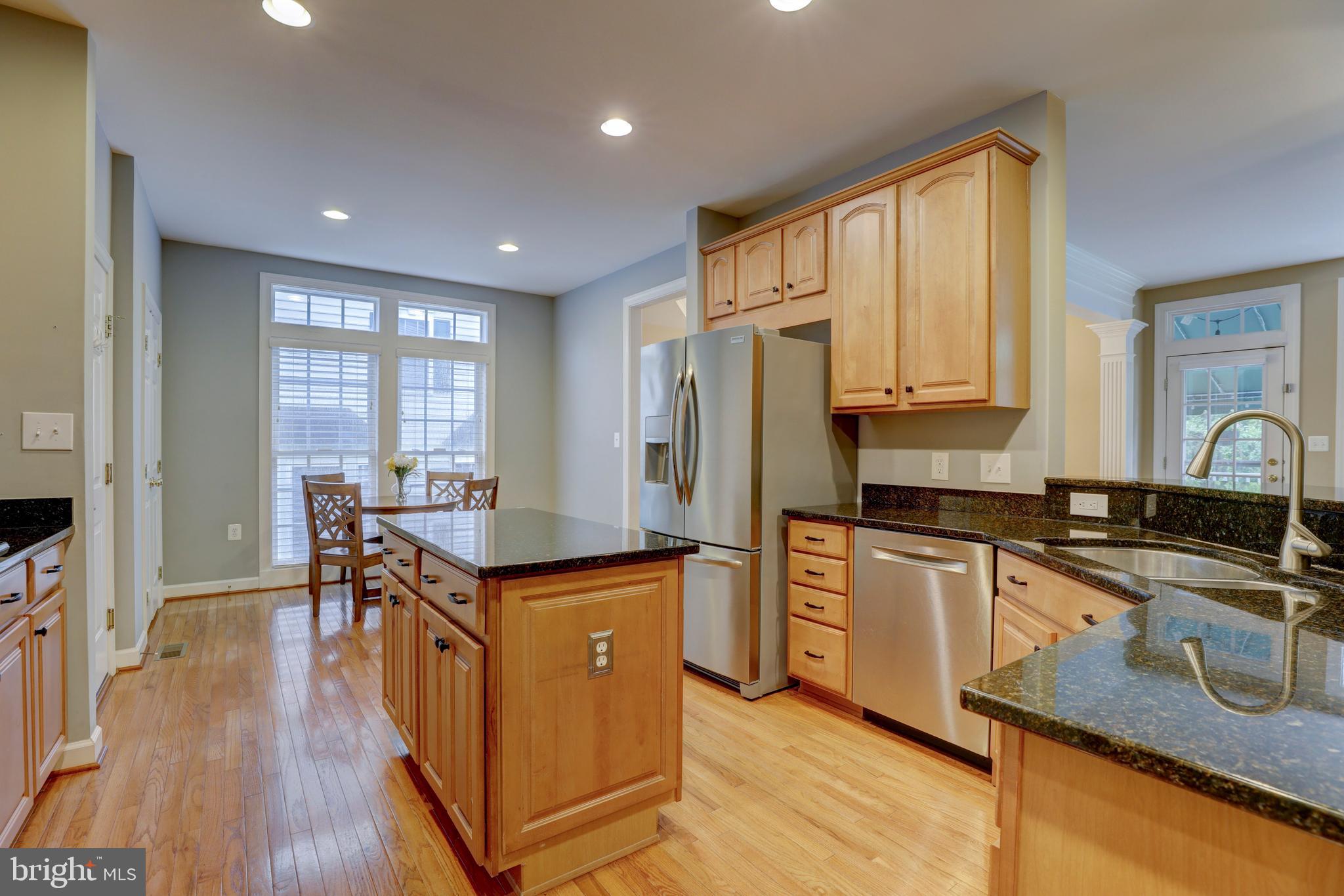 9124 Back Drop Drive Perry Hall, MD 21128 - Photo 15 of 69 a kitchen with granite countertop a stove a sink a refrigerator and wooden cabinets