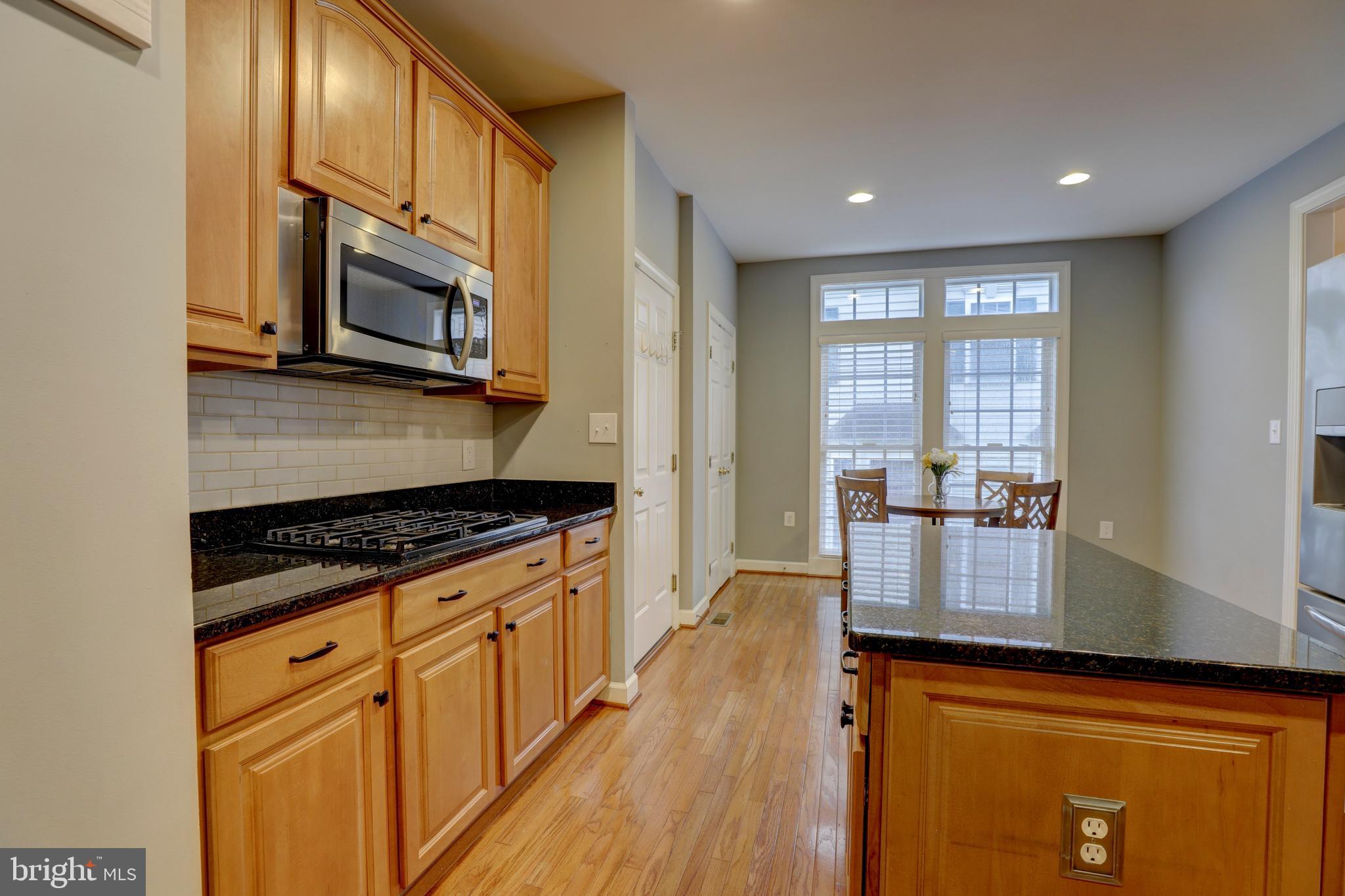 9124 Back Drop Drive Perry Hall, MD 21128 - Photo 16 of 69 a kitchen with stainless steel appliances granite countertop a stove a sink and a microwave