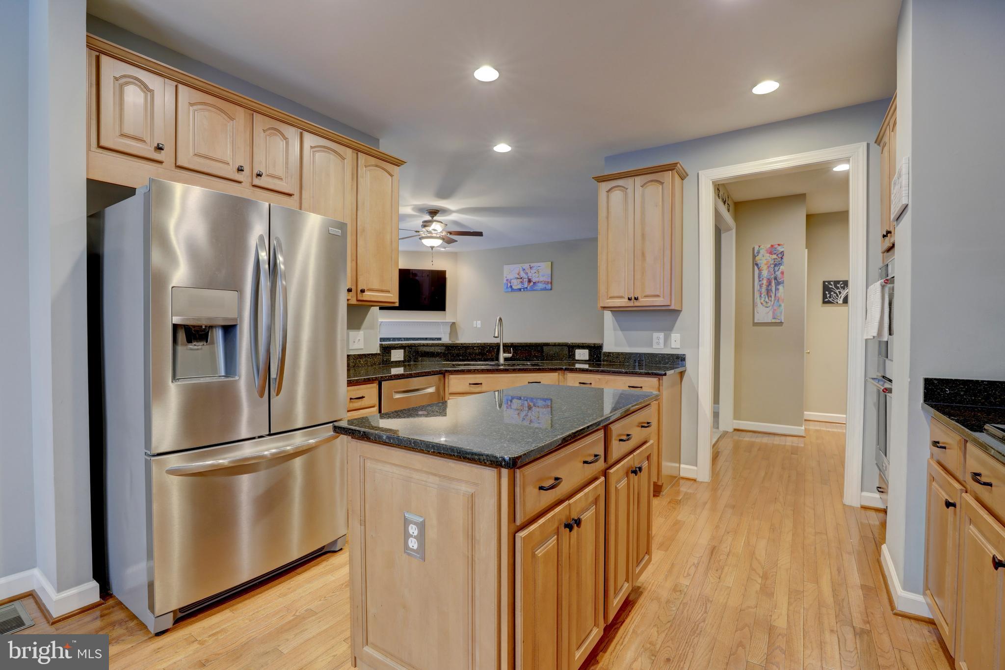 9124 Back Drop Drive Perry Hall, MD 21128 - Photo 17 of 69 a kitchen with stainless steel appliances granite countertop a refrigerator a stove a sink and a refrigerator