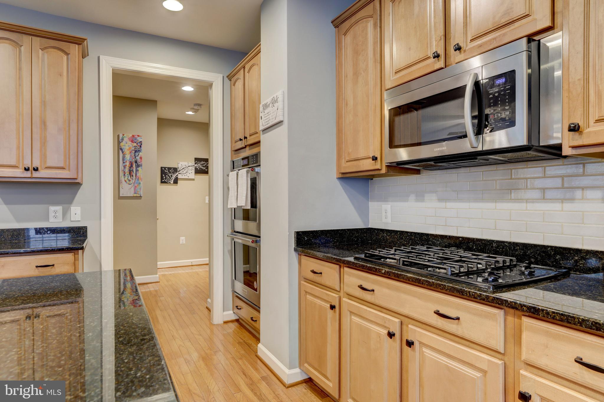 9124 Back Drop Drive Perry Hall, MD 21128 - Photo 18 of 69 a kitchen with stainless steel appliances granite countertop a stove a microwave and a refrigerator