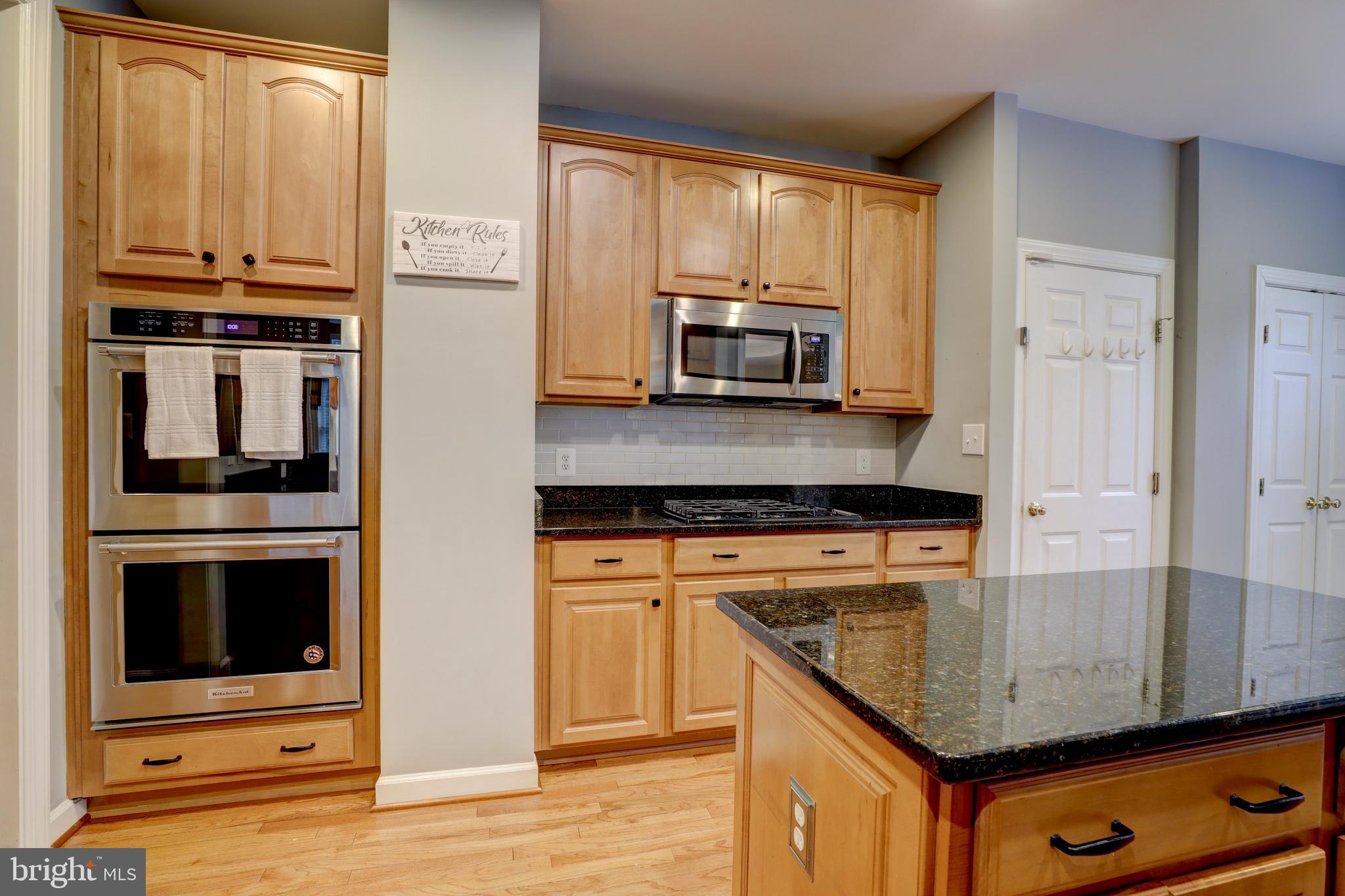 9124 Back Drop Drive Perry Hall, MD 21128 - Photo 20 of 69 a kitchen with stainless steel appliances granite countertop a stove a microwave and a sink