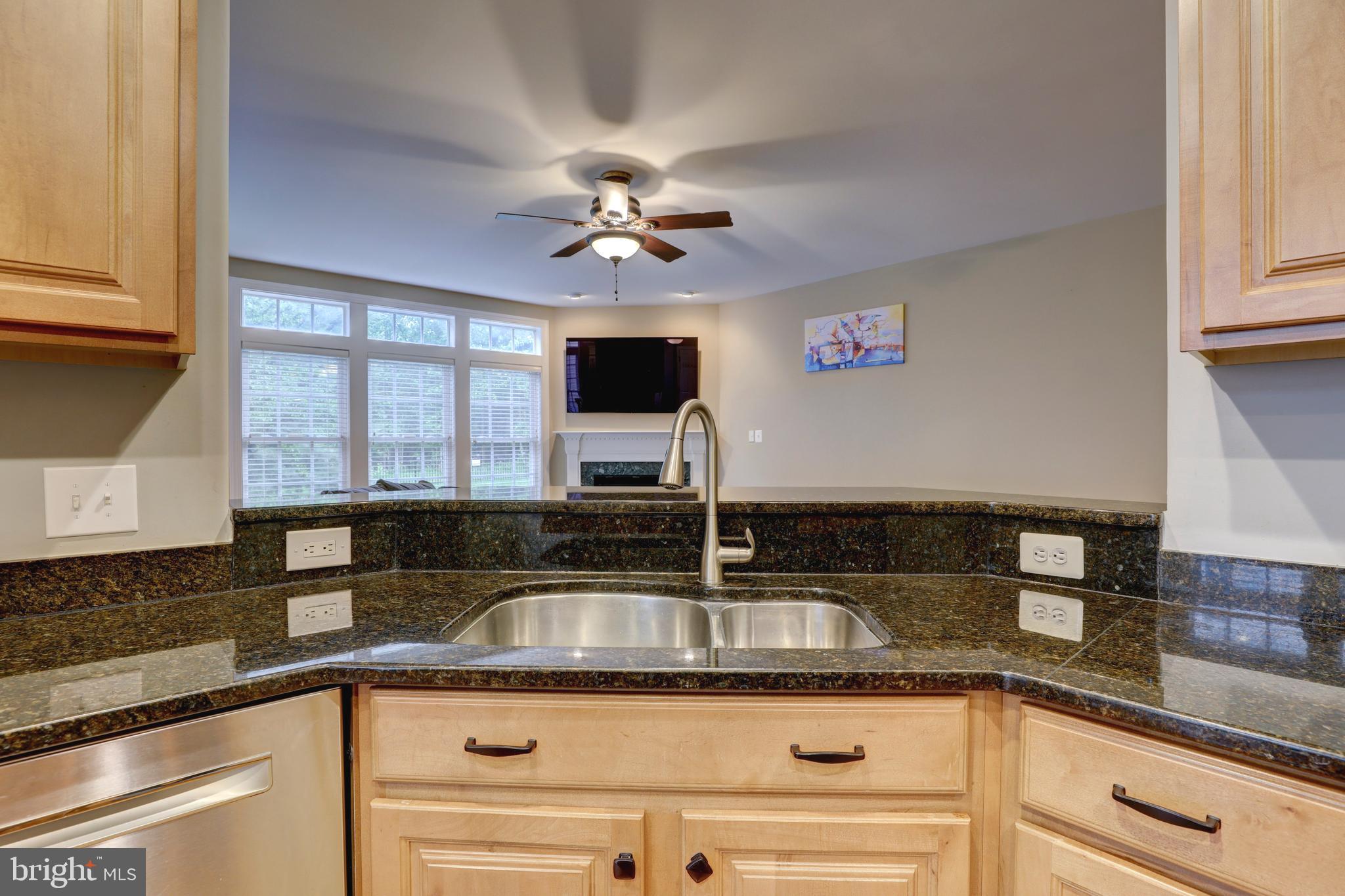 9124 Back Drop Drive Perry Hall, MD 21128 - Photo 21 of 69 a kitchen with granite countertop a sink a counter top space cabinets and stainless steel appliances