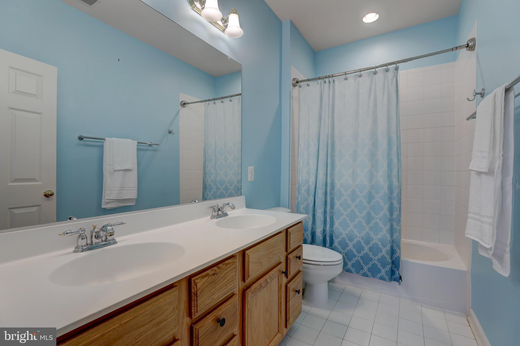9124 Back Drop Drive Perry Hall, MD 21128 - Photo 43 of 69 a bathroom with a double vanity sink toilet mirror and shower