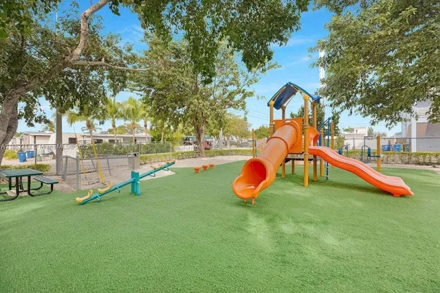 a view of playground with a slide and swing