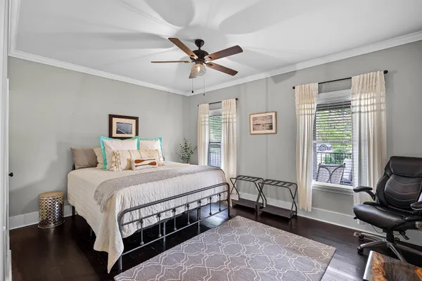 a bedroom with a bed chair and a window