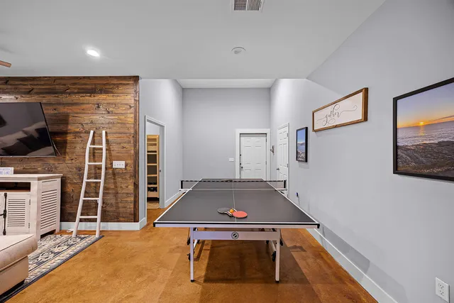 a room with pool table and windows