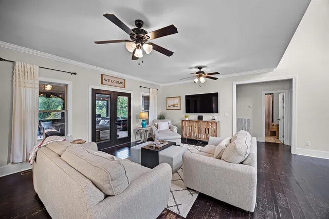 a living room with furniture a flat screen tv and a fireplace