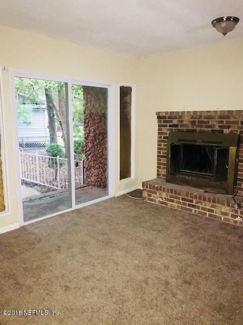5875 Spellman Road Jacksonville, FL 32209 - Photo 6 of 14 a view of empty room with floor to ceiling window and wooden floor
