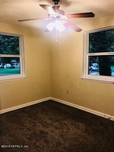 5875 Spellman Road Jacksonville, FL 32209 - Photo 10 of 14 a view of a small space with wooden floor and a window