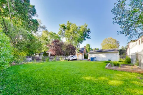 a view of a house with a yard and a garden