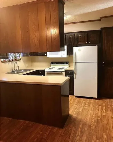 a kitchen with a sink a stove and refrigerator