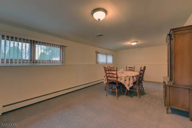a view of a dining room with furniture and a window