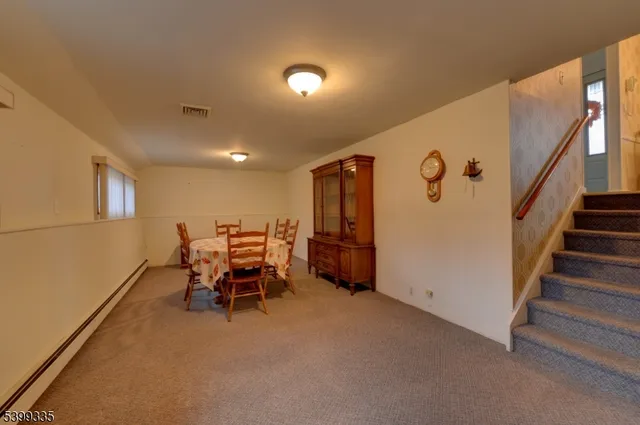 a view of a livingroom with furniture and a window