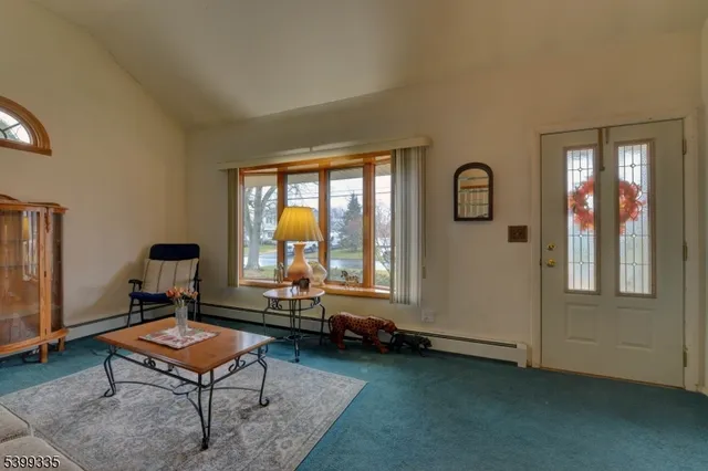 a living room with furniture pool table and a window