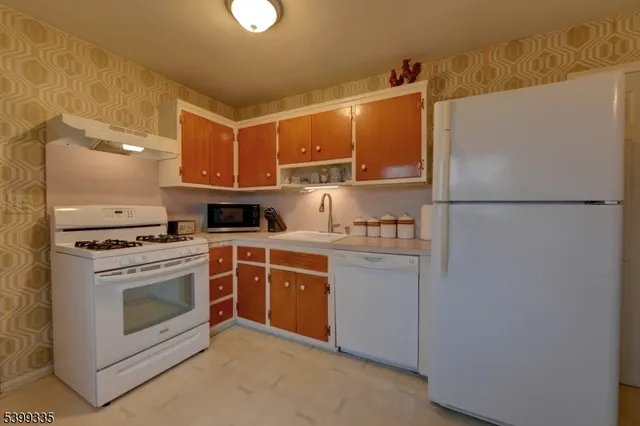 a white refrigerator freezer and a stove
