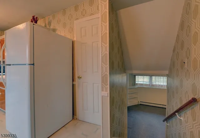 a white refrigerator freezer and a stove sitting inside of a kitchen