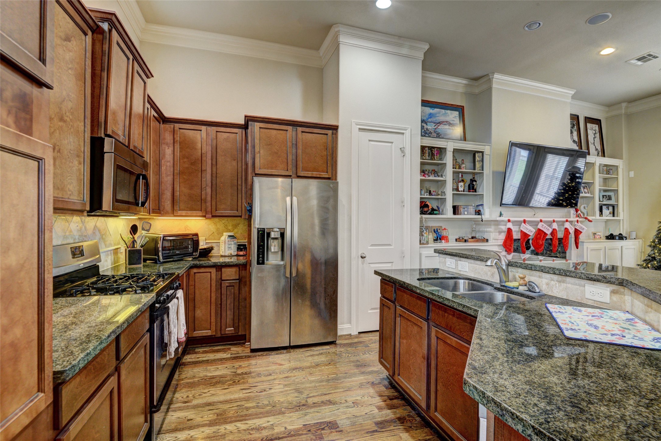 2803 Sherwin Street Houston, TX 77007 - Photo 4 of 19 a kitchen with stainless steel appliances granite countertop a refrigerator a stove top oven a sink and dishwasher