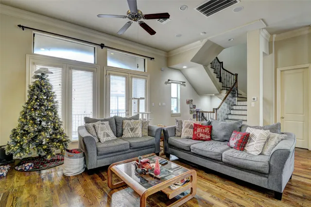 a living room with furniture and a christmas tree