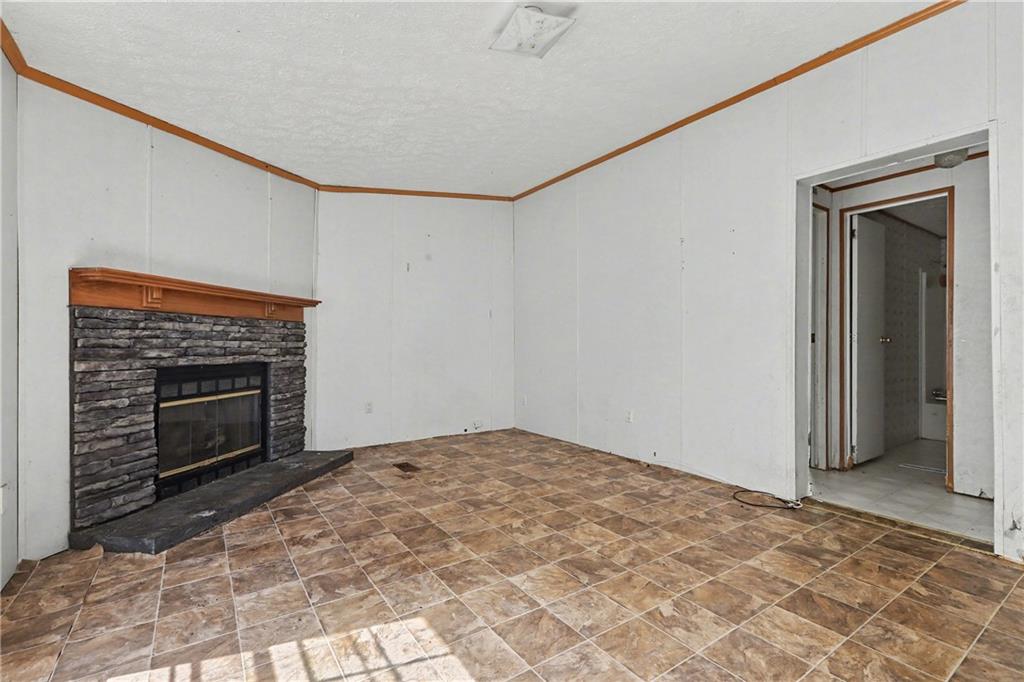 249 John Golden Road Temple, GA 30179 - Photo 24 of 45 a view of empty room with wooden floor and fireplace