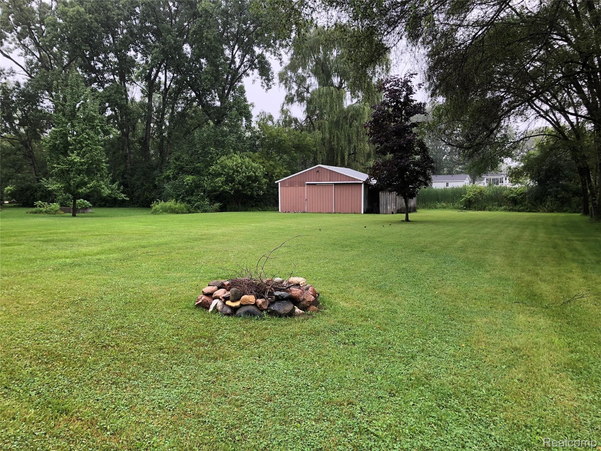 7018 Wilson Road Montrose, MI 48457 - Photo 23 of 24 View of large back yard with fire pit and pole barn