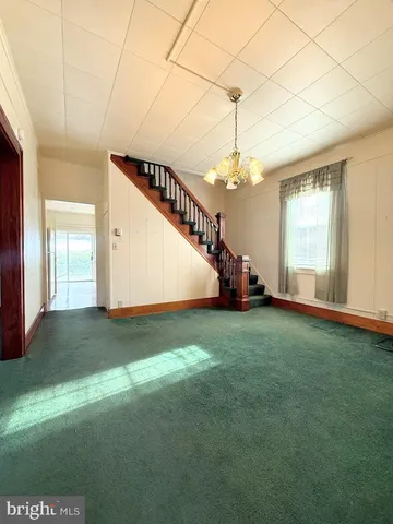 a kitchen with kitchen island a sink appliances and a large window