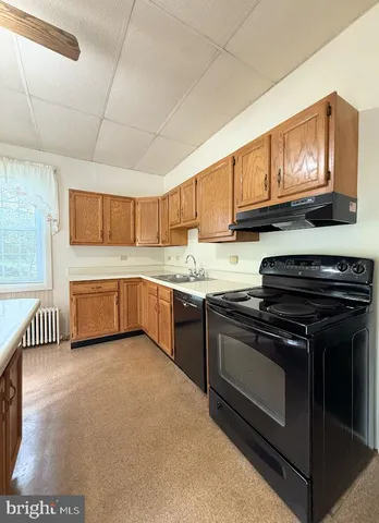 a view of a room with a table and chairs
