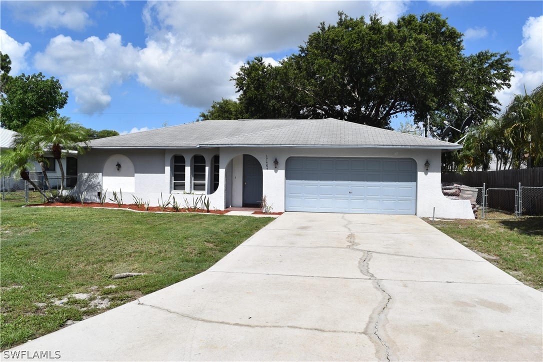 17404 Homewood Road Fort Myers, FL 33967 - Photo 1 of 26 front view of a house with a yard
