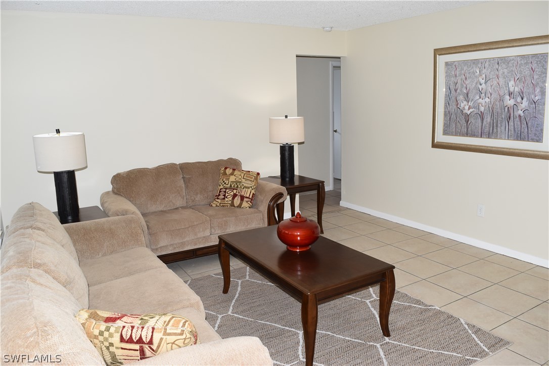 17404 Homewood Road Fort Myers, FL 33967 - Photo 12 of 26 a living room with furniture and a lamp