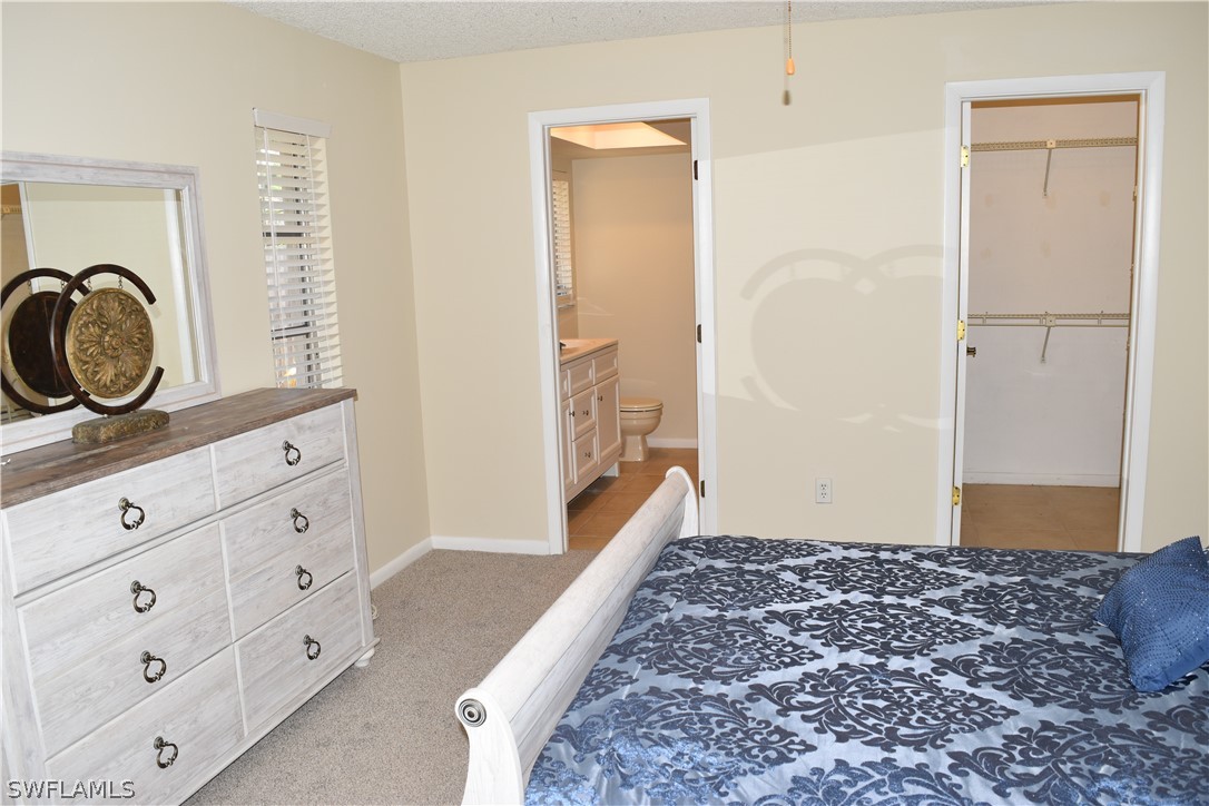17404 Homewood Road Fort Myers, FL 33967 - Photo 15 of 26 a bedroom with a bed and a window