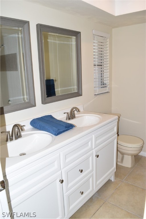17404 Homewood Road Fort Myers, FL 33967 - Photo 17 of 26 a bathroom with a sink a toilet and mirror