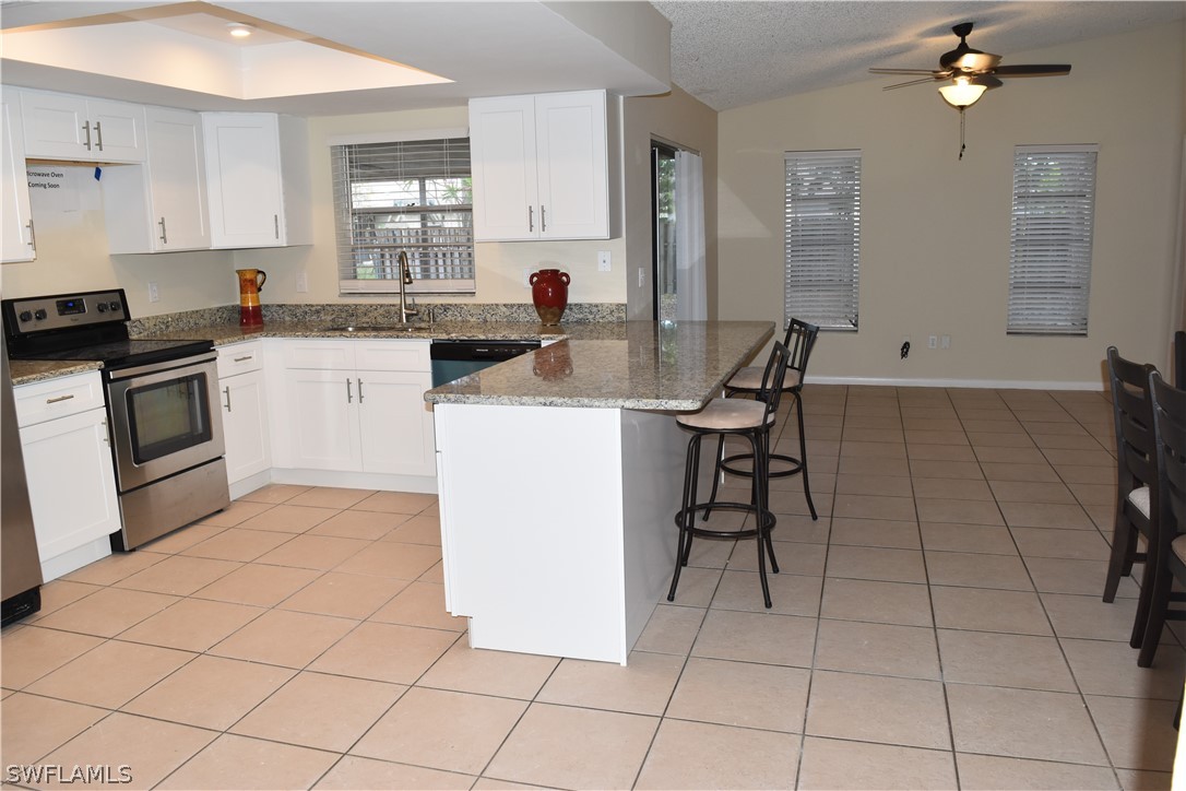 17404 Homewood Road Fort Myers, FL 33967 - Photo 3 of 26 a kitchen with a sink a stove and cabinets