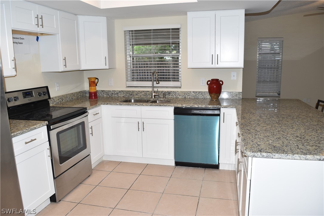 17404 Homewood Road Fort Myers, FL 33967 - Photo 4 of 26 a kitchen with granite countertop a sink stove and cabinets