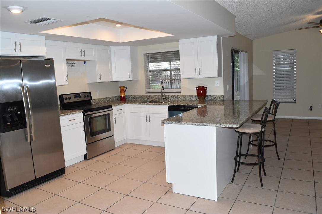 17404 Homewood Road Fort Myers, FL 33967 - Photo 6 of 26 a kitchen with a sink cabinets and stainless steel appliances