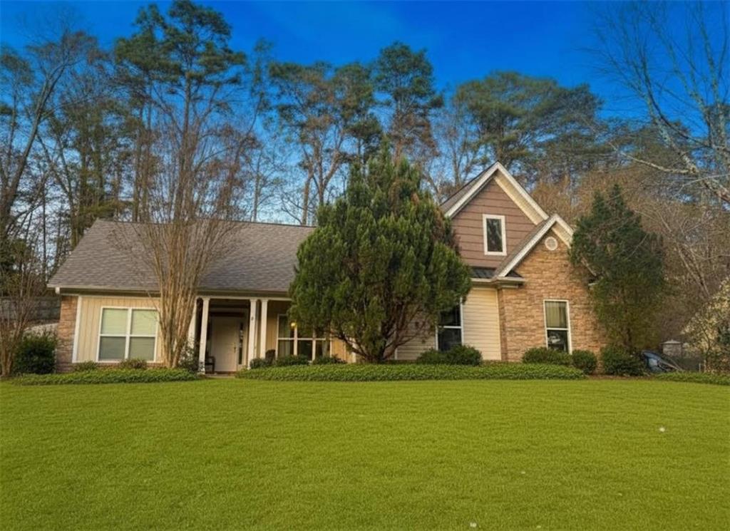a front view of a house with a garden