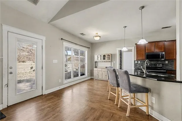 a view of kitchen with furniture and wooden floor