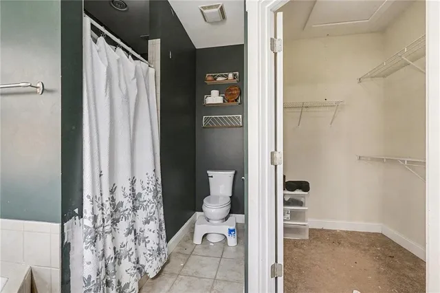 a bathroom with a shower and a toilet